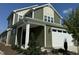 Two story green house with white garage door at 146 Swain St, Clayton, NC 27527
