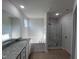 Main bathroom boasts granite countertop, soaking tub, and shower at 231 Lotus Ave, Smithfield, NC 27577