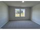 Well-lit bedroom with carpet and two large windows at 231 Lotus Ave, Smithfield, NC 27577