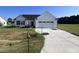 Newly built home with white siding and two-car garage at 231 Lotus Ave, Smithfield, NC 27577
