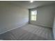 Simple bedroom with carpet flooring and a window at 231 Lotus Ave, Smithfield, NC 27577