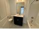 Simple bathroom with single vanity, toilet, and bathtub at 177 Swain St, Clayton, NC 27527