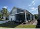 Front view of a two-toned house with a white garage door and landscaping at 177 Swain St, Clayton, NC 27527