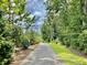 Paved walking trail winds through a lush, wooded area at 177 Swain St, Clayton, NC 27527