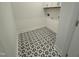 Laundry room with overhead cabinets and patterned floor tile at 177 Swain St, Clayton, NC 27527