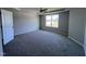 Spacious bedroom with plush carpeting and a large window at 218 Lotus Ave, Smithfield, NC 27577