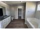 Bathroom with soaking tub, granite vanity and walk-in shower at 218 Lotus Ave, Smithfield, NC 27577