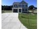 Two-story house with gray siding and attached garage at 218 Lotus Ave, Smithfield, NC 27577