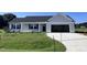One-story house with gray siding, a dark gray door, and a two-car garage at 138 Lotus Ave, Smithfield, NC 27577