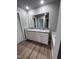 Bathroom with double vanity, granite countertop, and soaking tub at 138 Lotus Ave, Smithfield, NC 27577