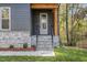 Front entrance with stone steps and a wooden covered porch at 420 Clayton Rd, Durham, NC 27703