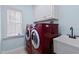 Convenient laundry room with a sink, cabinets, and red appliances at 19 Silverside Dr, Angier, NC 27501