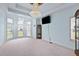 Spacious living room with light blue walls, large windows, and a chandelier at 19 Silverside Dr, Angier, NC 27501