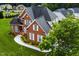 Aerial view of a two-story brick house with landscaped yard at 19 Silverside Dr, Angier, NC 27501