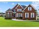 Brick two-story house with a landscaped lawn at 19 Silverside Dr, Angier, NC 27501