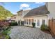 Backyard patio area with access to the house, surrounded by plants and trees at 3614 Lion Ridge Ct, Raleigh, NC 27612