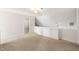 Hallway with built-in white cabinets, beige carpet, and a walk-in closet at 3614 Lion Ridge Ct, Raleigh, NC 27612