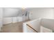 Upstairs hallway with beige carpet, built-in shelving, and a staircase at 3614 Lion Ridge Ct, Raleigh, NC 27612