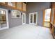 Enclosed back porch with multiple doors and windows at 1203 Keith Hills Rd, Lillington, NC 27546