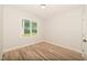 Bright bedroom with hardwood floors and a large window at 114 Shaman Dr, Louisburg, NC 27549