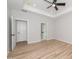 Spacious bedroom with wood-look floors and access to bathroom at 114 Shaman Dr, Louisburg, NC 27549