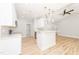 Modern kitchen with white cabinets, quartz countertops, and gold accents at 114 Shaman Dr, Louisburg, NC 27549