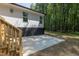 Concrete patio adjacent to deck and wooded area at 114 Shaman Dr, Louisburg, NC 27549