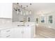 Modern kitchen boasts a large island, white cabinets, and gold fixtures at 114 Shaman Dr, Louisburg, NC 27549