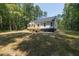 Home exterior showcasing backyard and wooded lot at 114 Shaman Dr, Louisburg, NC 27549