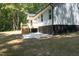 Rear view of house showcasing deck and patio at 114 Shaman Dr, Louisburg, NC 27549