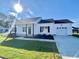 White house with front porch, black door, and two-car garage at 36 Kevior Ave, Four Oaks, NC 27524