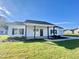 White house with front porch, black door, and two-car garage at 36 Kevior Ave, Four Oaks, NC 27524