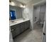 Double vanity bathroom with gray cabinets and a bathtub at 1013 Bostonian Dr, Knightdale, NC 27545