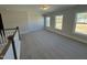 Large bonus room with hardwood floors and access to balcony at 1013 Bostonian Dr, Knightdale, NC 27545