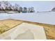 Private backyard with concrete patio and white vinyl fence at 36 Kevior Ave, Four Oaks, NC 27524