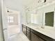 Bathroom with a double vanity and view of bedroom at 36 Kevior Ave, Four Oaks, NC 27524
