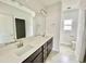Double vanity bathroom with dark brown cabinets at 36 Kevior Ave, Four Oaks, NC 27524