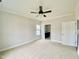 Bright bedroom with carpet, ceiling fan, and en-suite bathroom at 36 Kevior Ave, Four Oaks, NC 27524