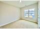 Well-lit bedroom with carpeted floor and window at 36 Kevior Ave, Four Oaks, NC 27524