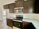 Kitchen boasts granite countertops and stainless steel appliances at 36 Kevior Ave, Four Oaks, NC 27524