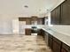 Modern kitchen with dark wood cabinets and granite counters at 36 Kevior Ave, Four Oaks, NC 27524