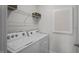 Bright laundry room with washer, dryer, and shelving at 2209 Fletchers Ridge Dr, Durham, NC 27703