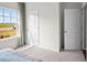 Well-lit bedroom with a large window offering an exterior view and closet at 2209 Fletchers Ridge Dr, Durham, NC 27703