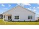 Two-story house with light beige vinyl siding, a covered patio, and a grassy backyard at 2209 Fletchers Ridge Dr, Durham, NC 27703