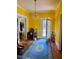 Bright living room with yellow walls and hardwood floors at 521 E Edenton St, Raleigh, NC 27601