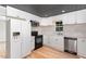 Modern kitchen with white cabinets and tin ceiling at 2113 Eveton Ln, Sanford, NC 27330