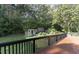 Wooden deck overlooking a backyard with trees and shed at 2113 Eveton Ln, Sanford, NC 27330
