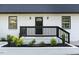 Front door with black railing and white brick at 2113 Eveton Ln, Sanford, NC 27330