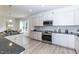 Modern kitchen with stainless steel appliances and granite countertops at 84 Rosslyn Way # 92, Garner, NC 27529