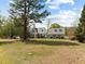 Gray two-story house with large yard and mature trees at 11609 Us-401, Fuquay Varina, NC 27526